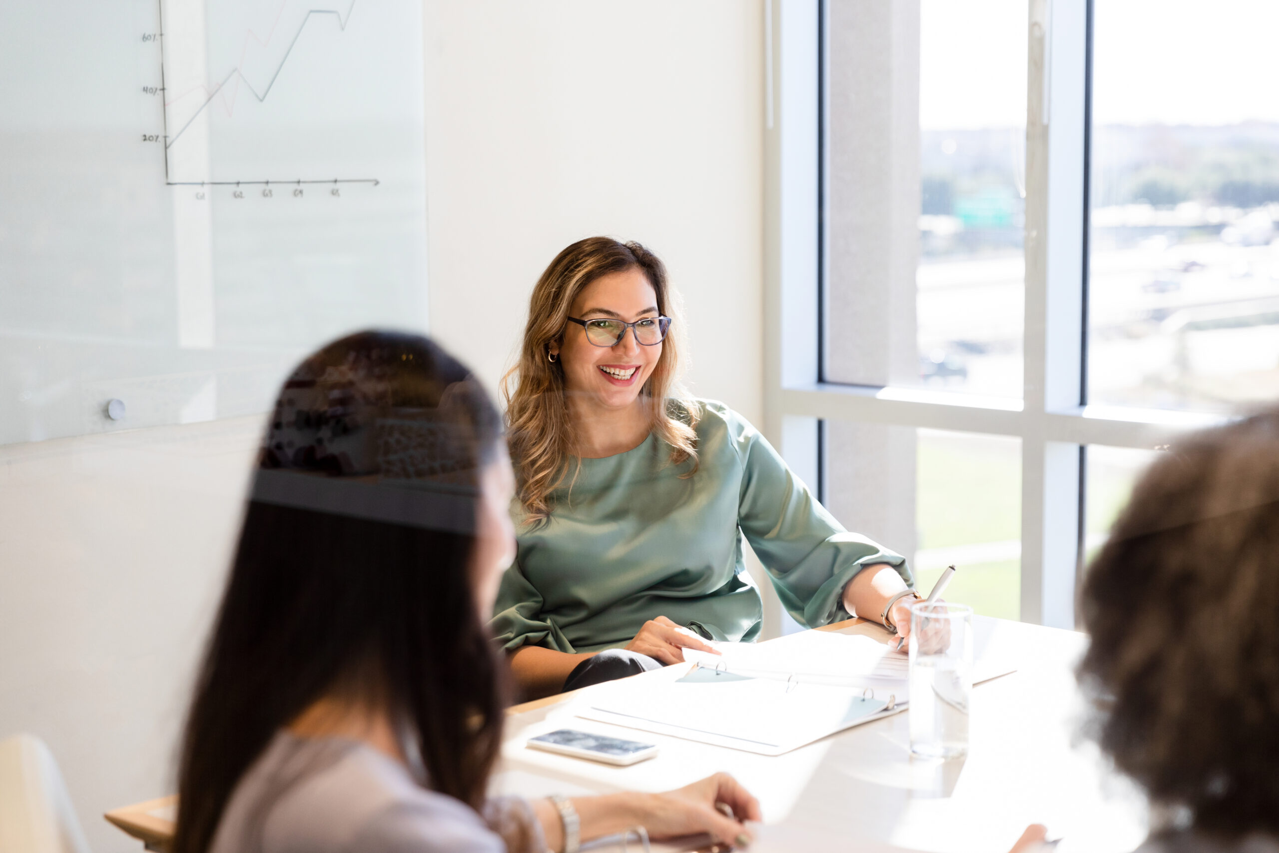 Female marketing agent smiling and talking in the meeting - stock photo