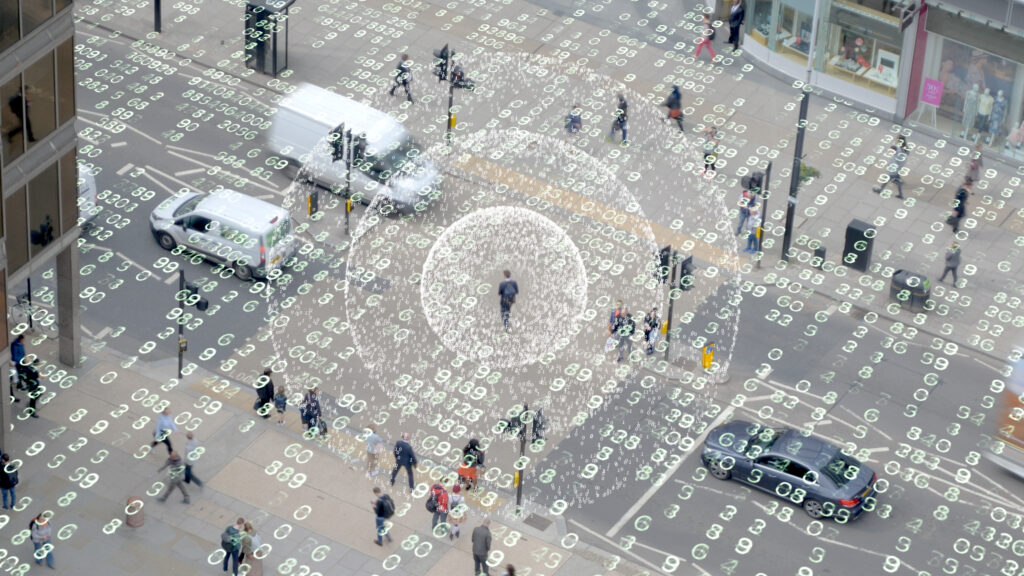 Data overlaying a busy street corner in a downtown city