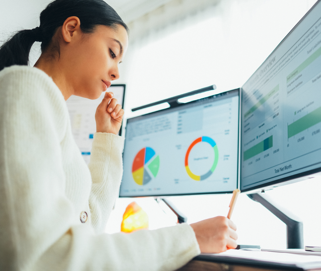 Young analyst uses AI to generate patient services data.