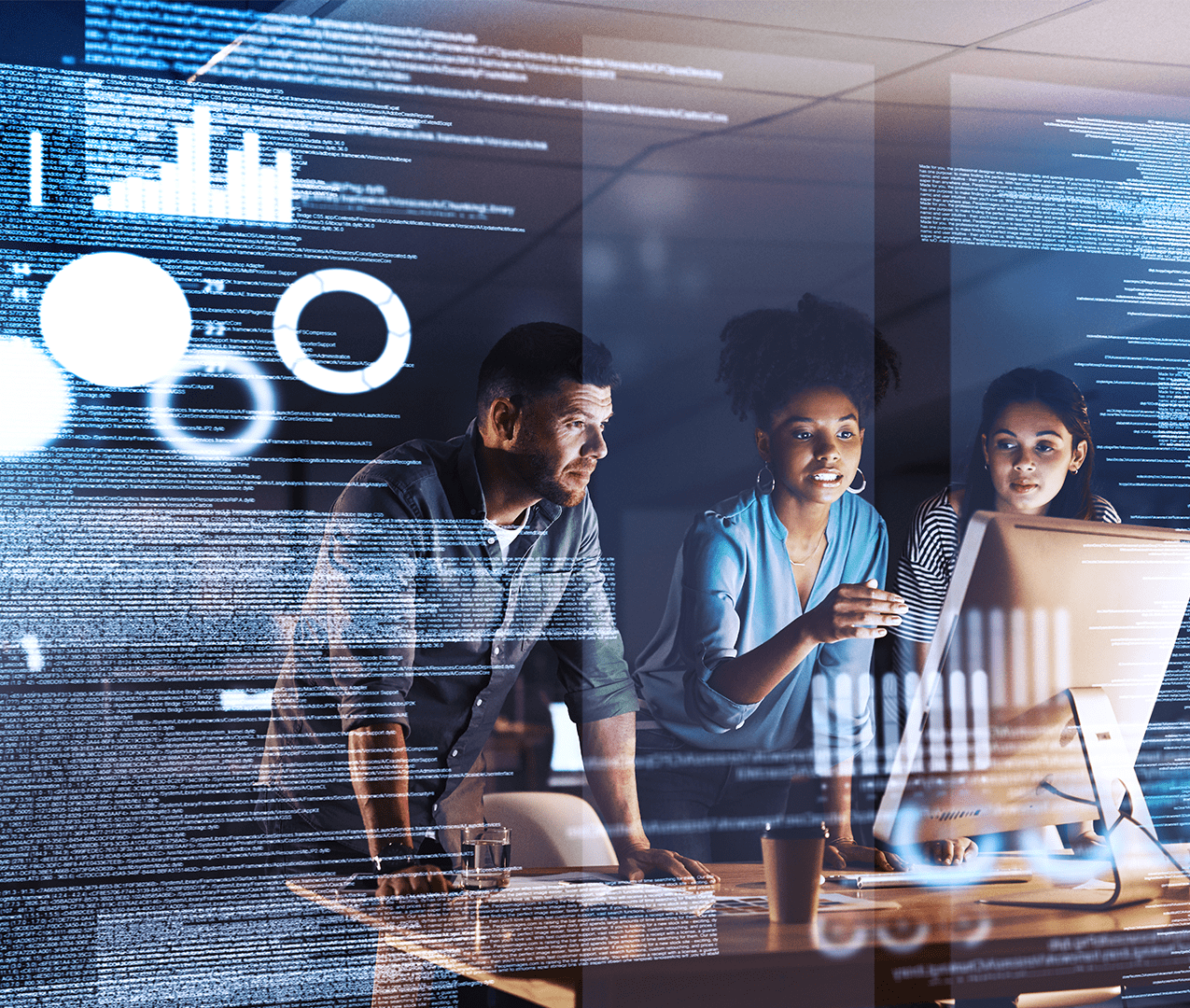 Team of diverse business people looking at a computer and discussing analytics with an imprint of the data overlaying the photo including lots of text and graphs. Data and analytics concept.