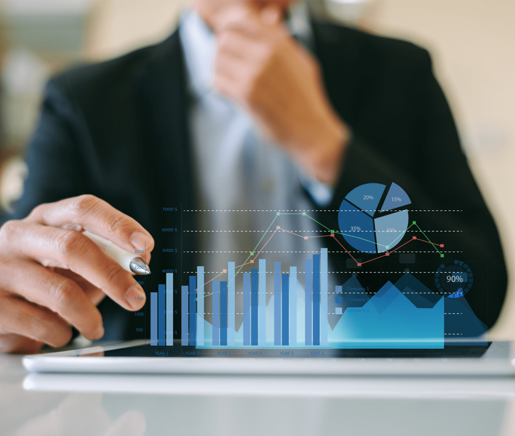 Business man looking at a tablet on the table and thinking as he studies the charts and graphs popping out of the screen.