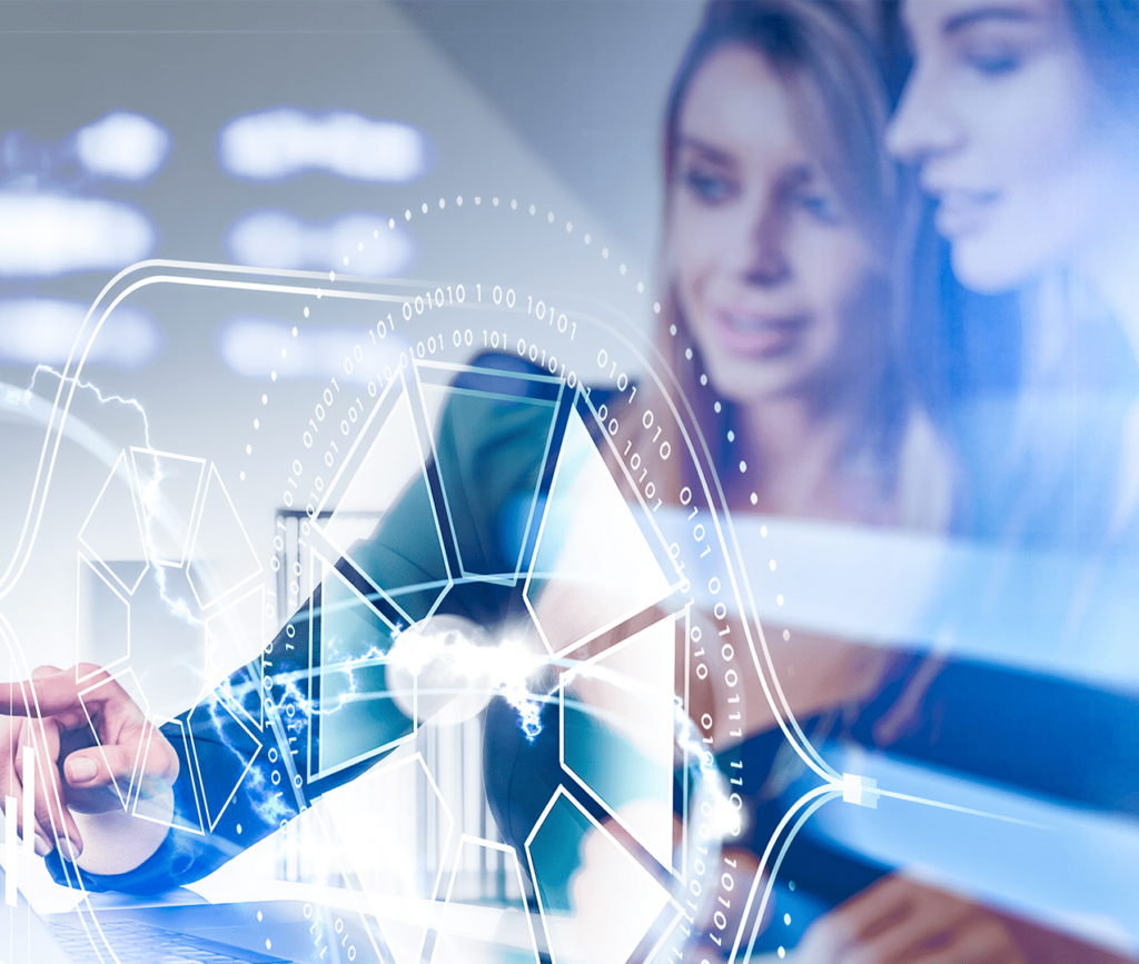 Technology concept showing two women analyzing and pointing to data insights on a computer that is overlaid on the image in a holograph.