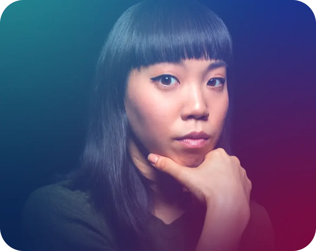 A woman with dark hair and bangs, wearing a dark top, rests her chin on her hand, looking thoughtfully at the viewer. The background is a gradient of dark blue, purple, and red.